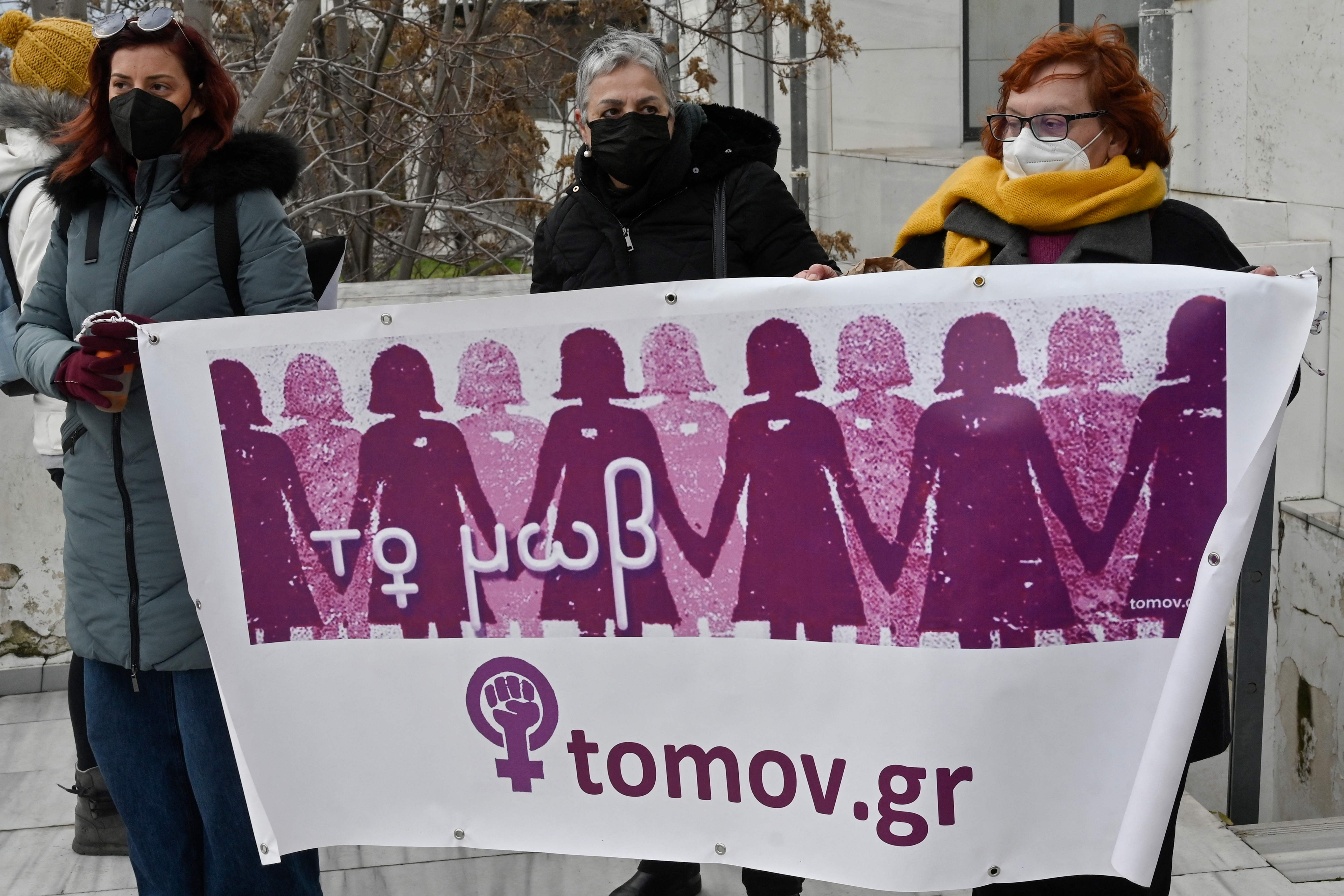 Feminist organisations hold a banner outside a court in Athens, Greece, 12 January 2022