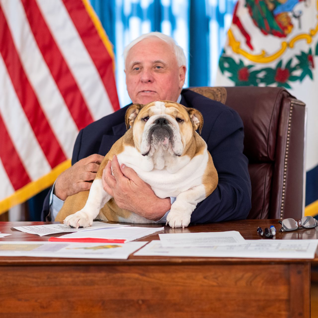 West Virginia governor Jim Justice holds his English bulldog Babydog