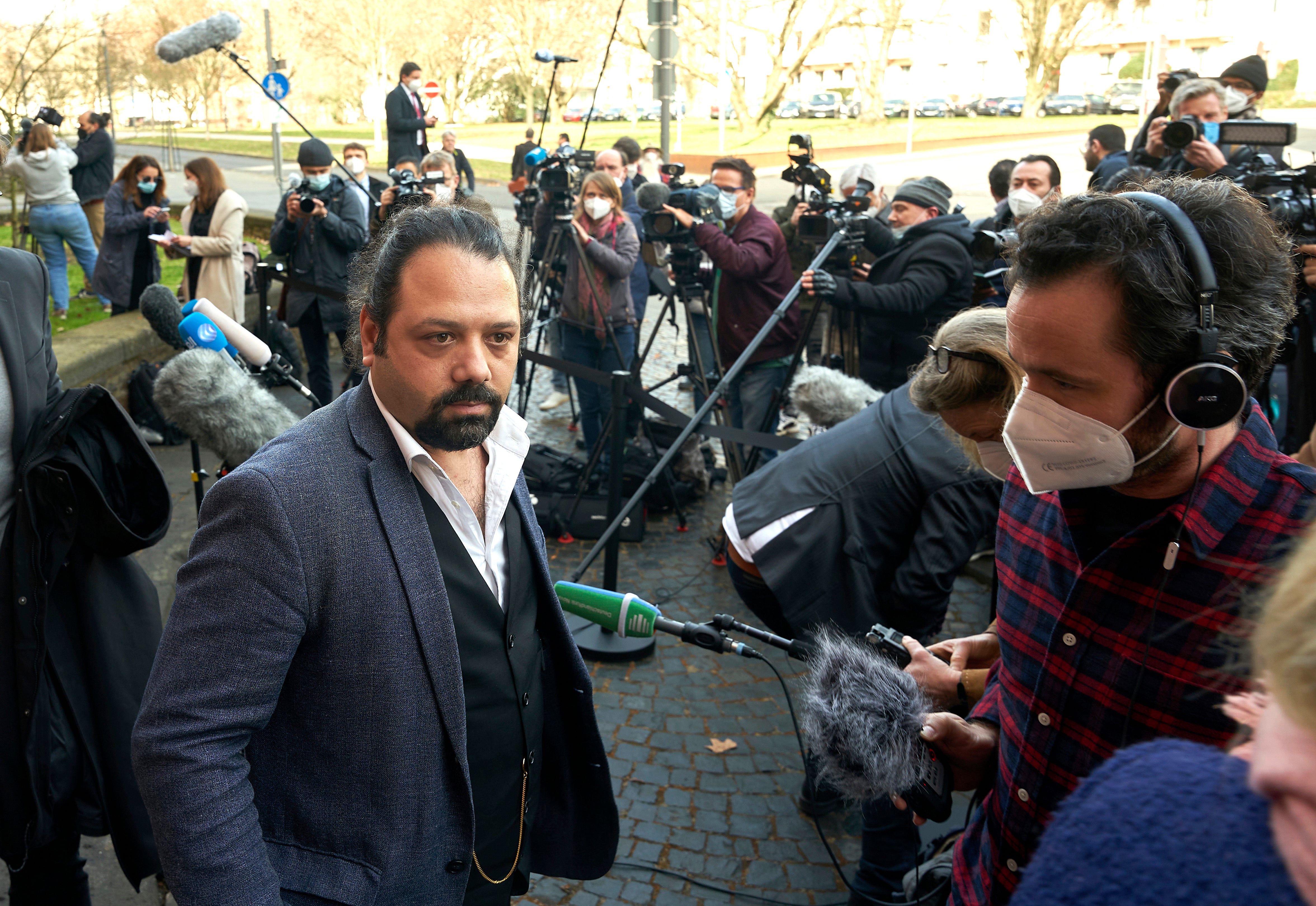 File photo: Wassim Mukdad talks to journalists outside the court in Koblenz, Germany, 24 February 2021