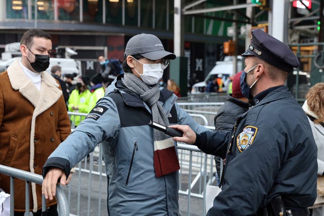 <p>A New York City Police Department (NYPD) officer performs a security check </p>