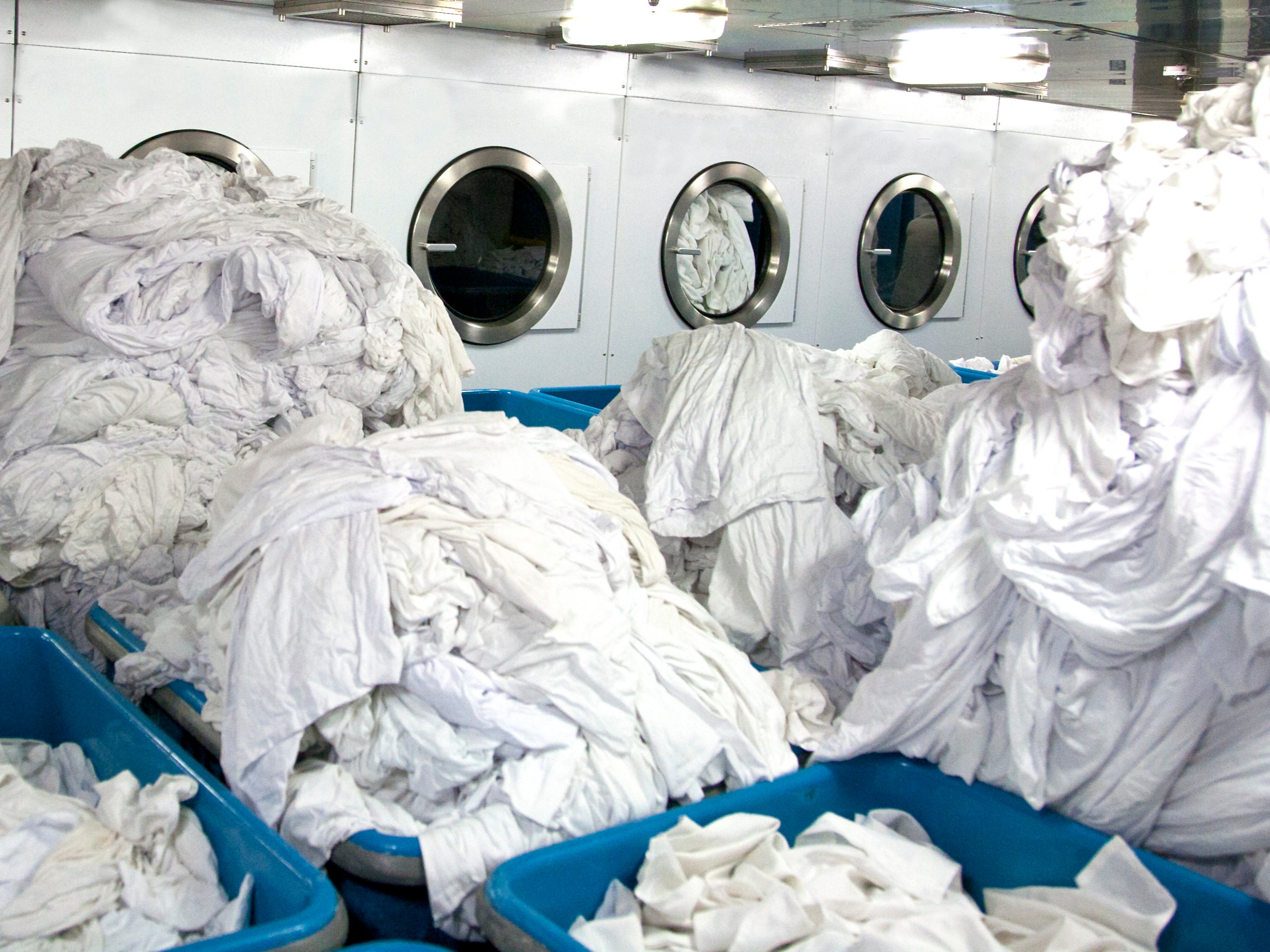 Mountains of sheets about to go into drying machines. Up to 40 times more microscopic fragments were generated by dryers than washing machines, scientists found in tests