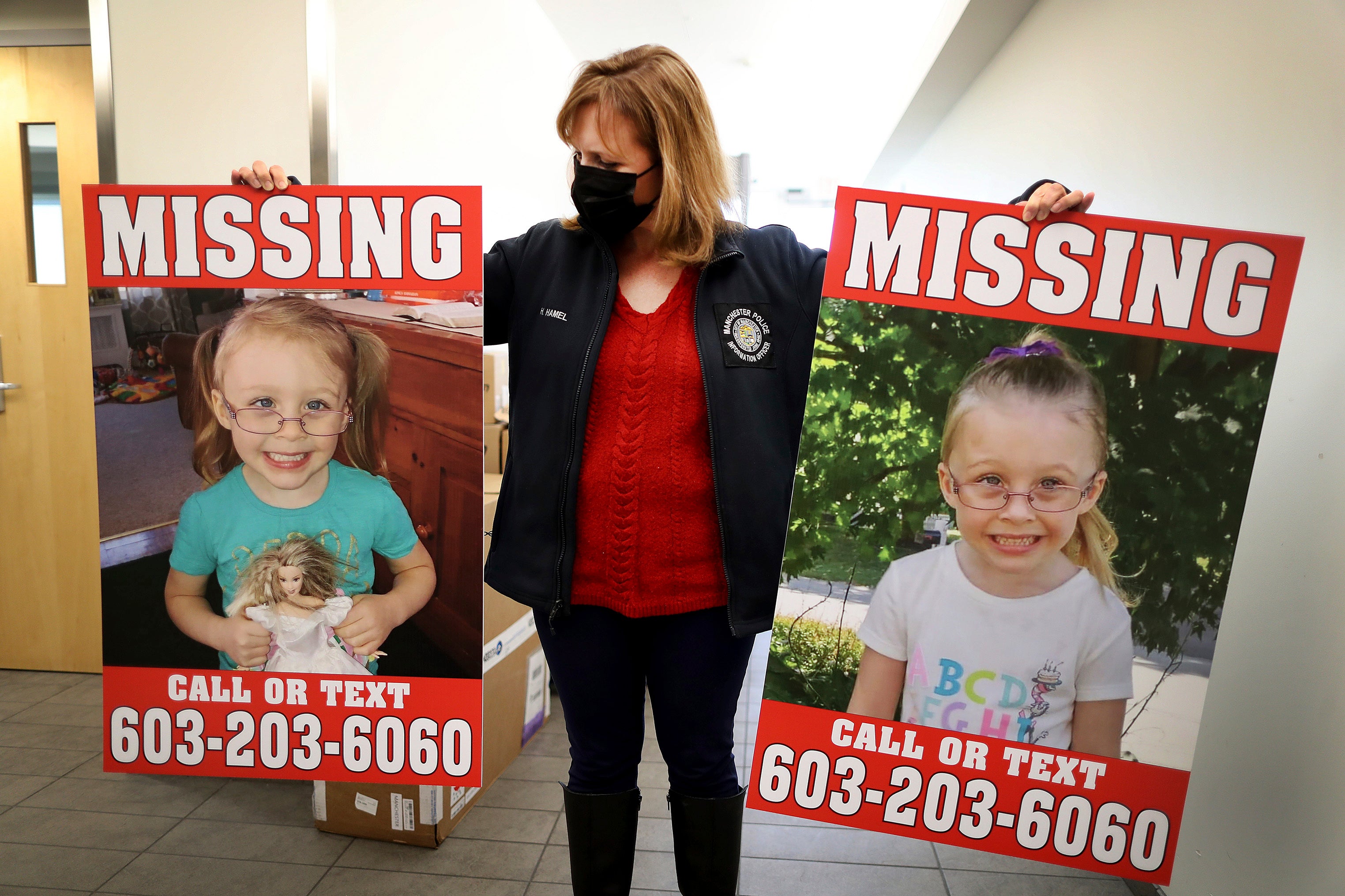 Manchester Police Public Information Officer Heather Hamel holds two reward posters, Tuesday, Jan. 4, 2022, in Manchester, NH