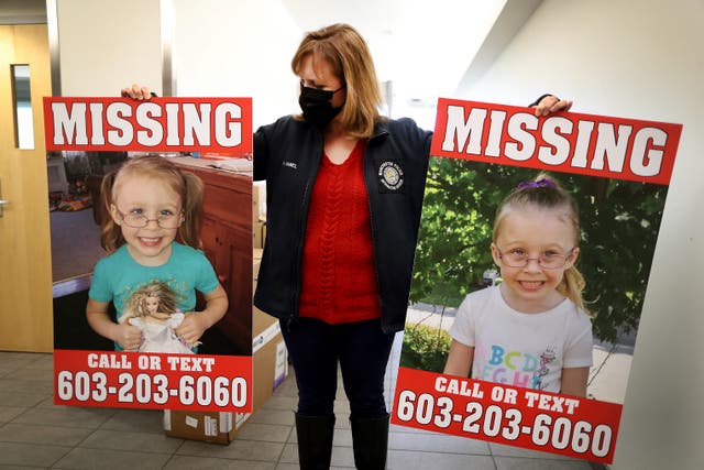 <p>Manchester Police Public Information Officer Heather Hamel holds two reward posters, Tuesday, Jan. 4, 2022, in Manchester, NH</p>