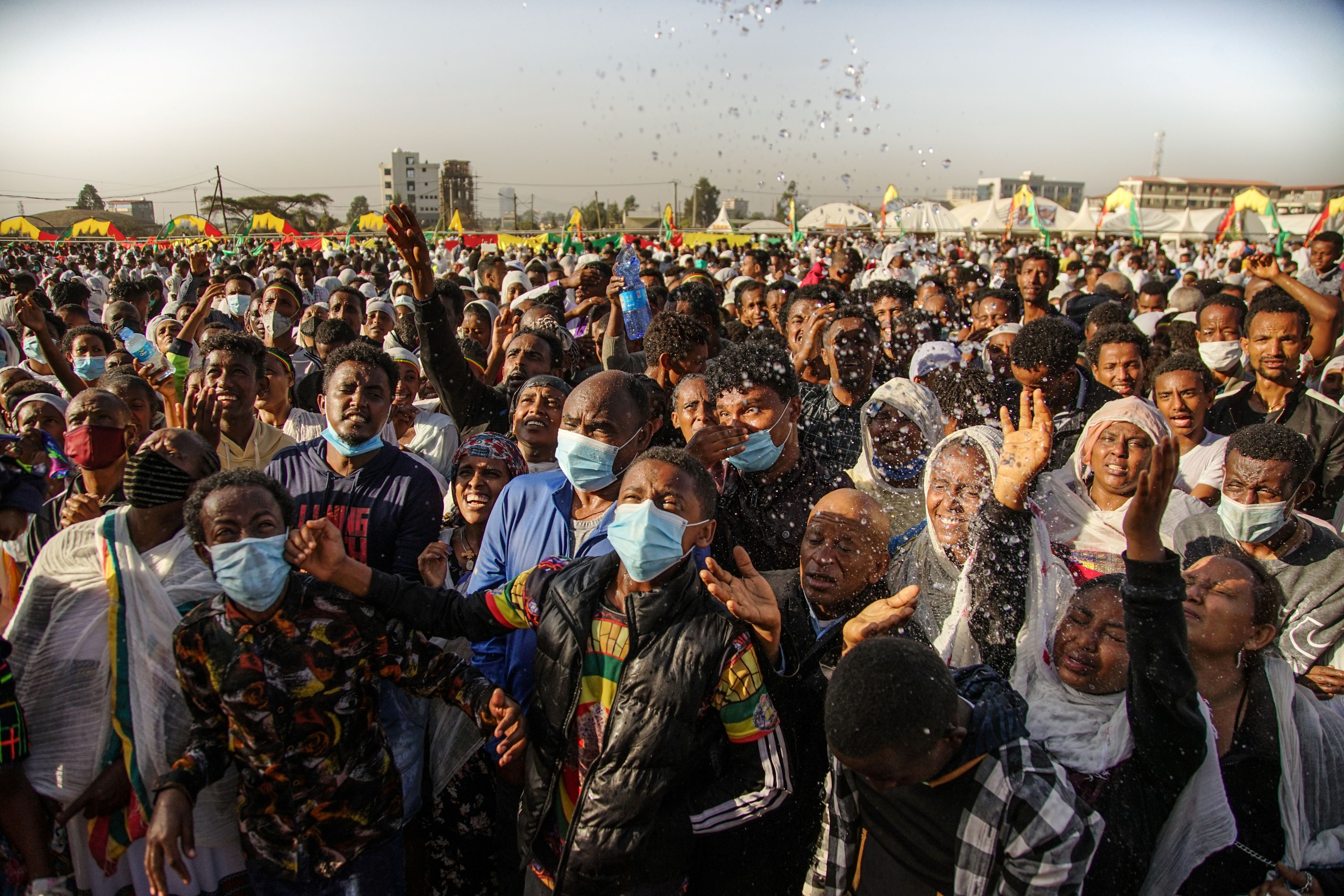 Ethiopian Orthodox Christian worshippers get holy water sprayed on their faces in Addis Ababa, Ethiopia, on 19 January 2021