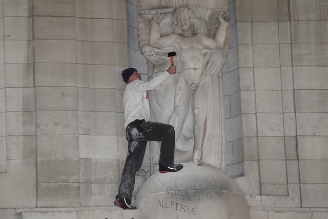 A man after he climbed onto the statues Prospero and Ariel from Shakespeare’s play The Tempest by the sculptor Eric Gill outside of the BBC’s headquarters in central London and hit them with hammer. The Metropolitan Police said officers were called at around 4.15pm on Wednesday to Broadcasting House on Portland Street, Westminster (Ian West/PA)