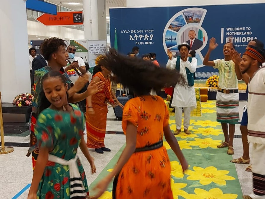 Traditional dancers greet diaspora Ethiopians arriving at Bole International Airport in Addis Ababa