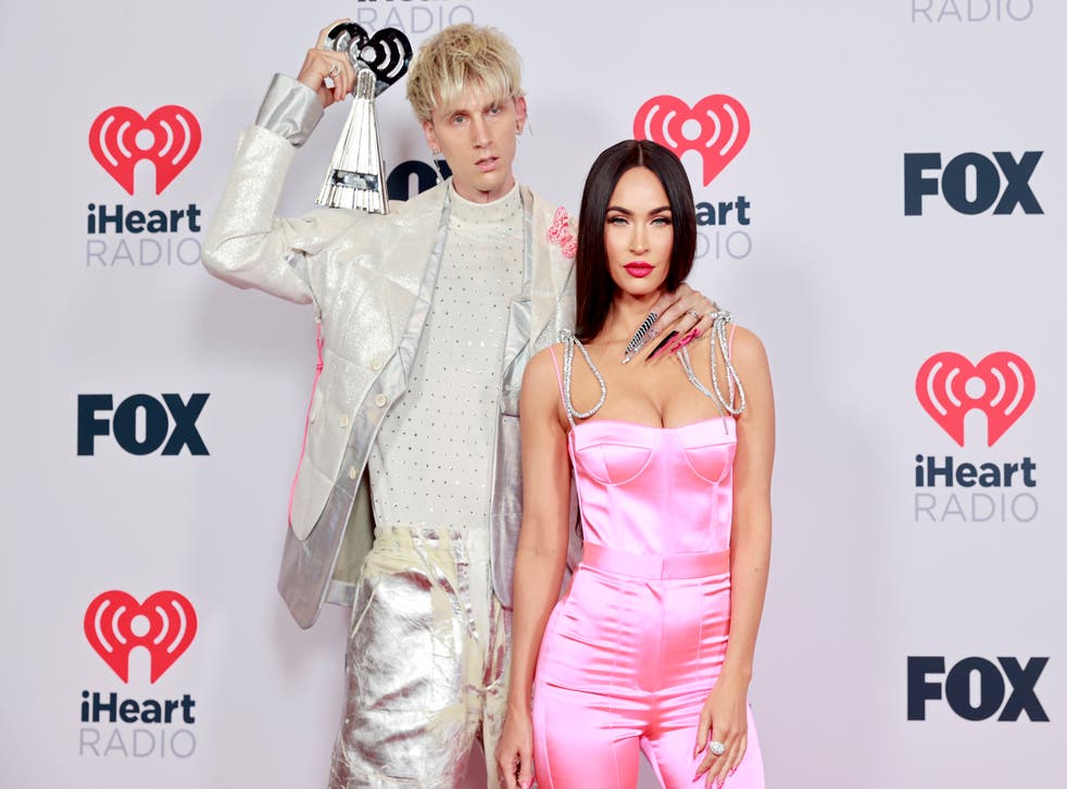 <p>Machine Gun Kelly, winner of the Alternative Rock Album of the Year award for 'Tickets To My Downfall,’ and Megan Fox attend the 2021 iHeartRadio Music Awards at The Dolby Theatre in Los Angeles, California</p>