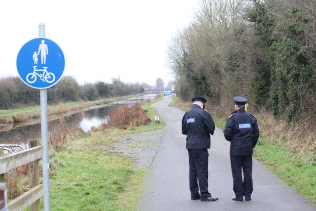 Gardai officers at the Grand canal in Tullamore after a young woman, who has been named locally as Ashling Murphy, was killed in Co Offaly (PA)