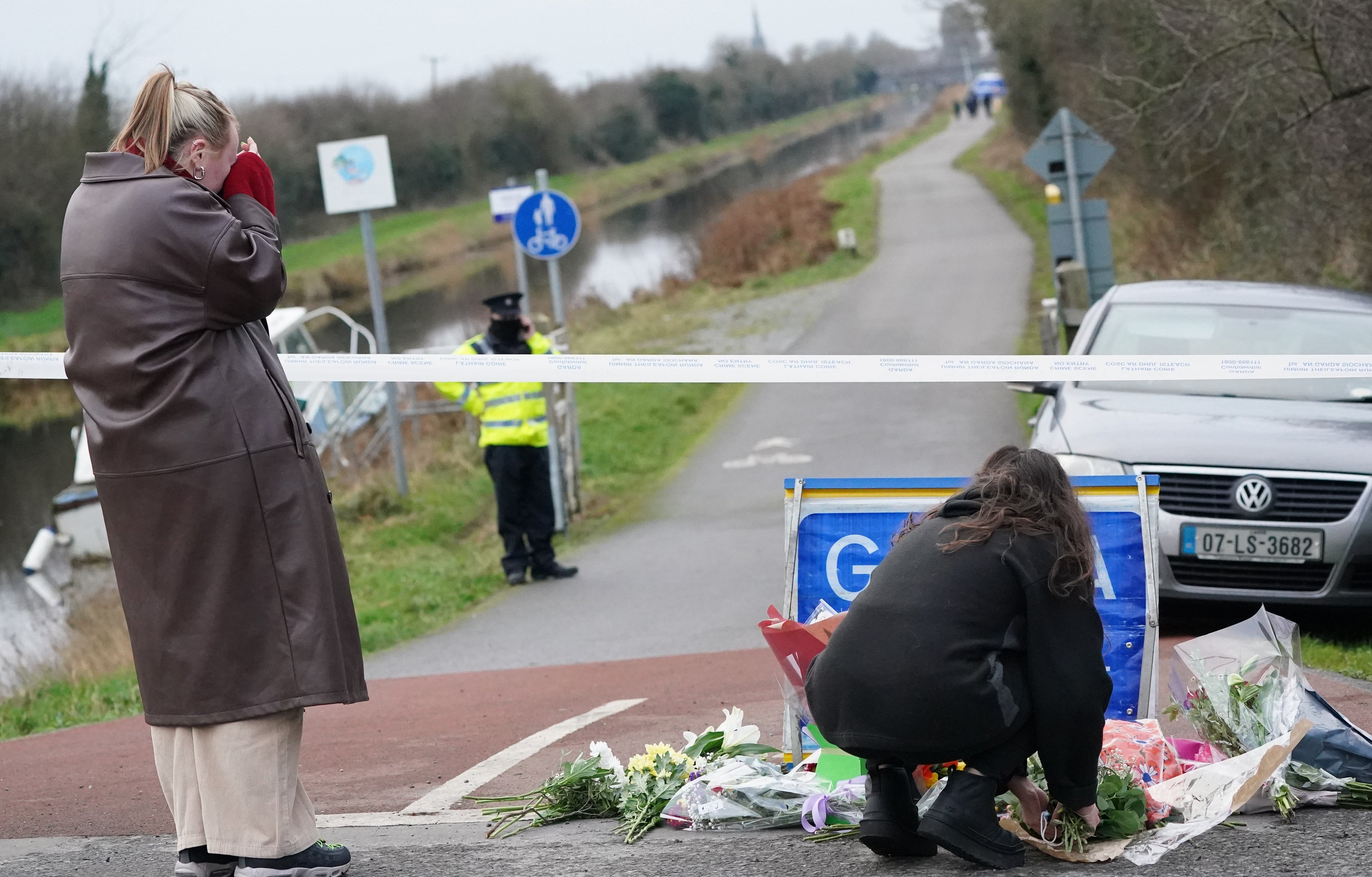 A person lays flowers near to the place in Tullamore, Co Offaly, where the teacher was killed (Brian Lawless/PA)