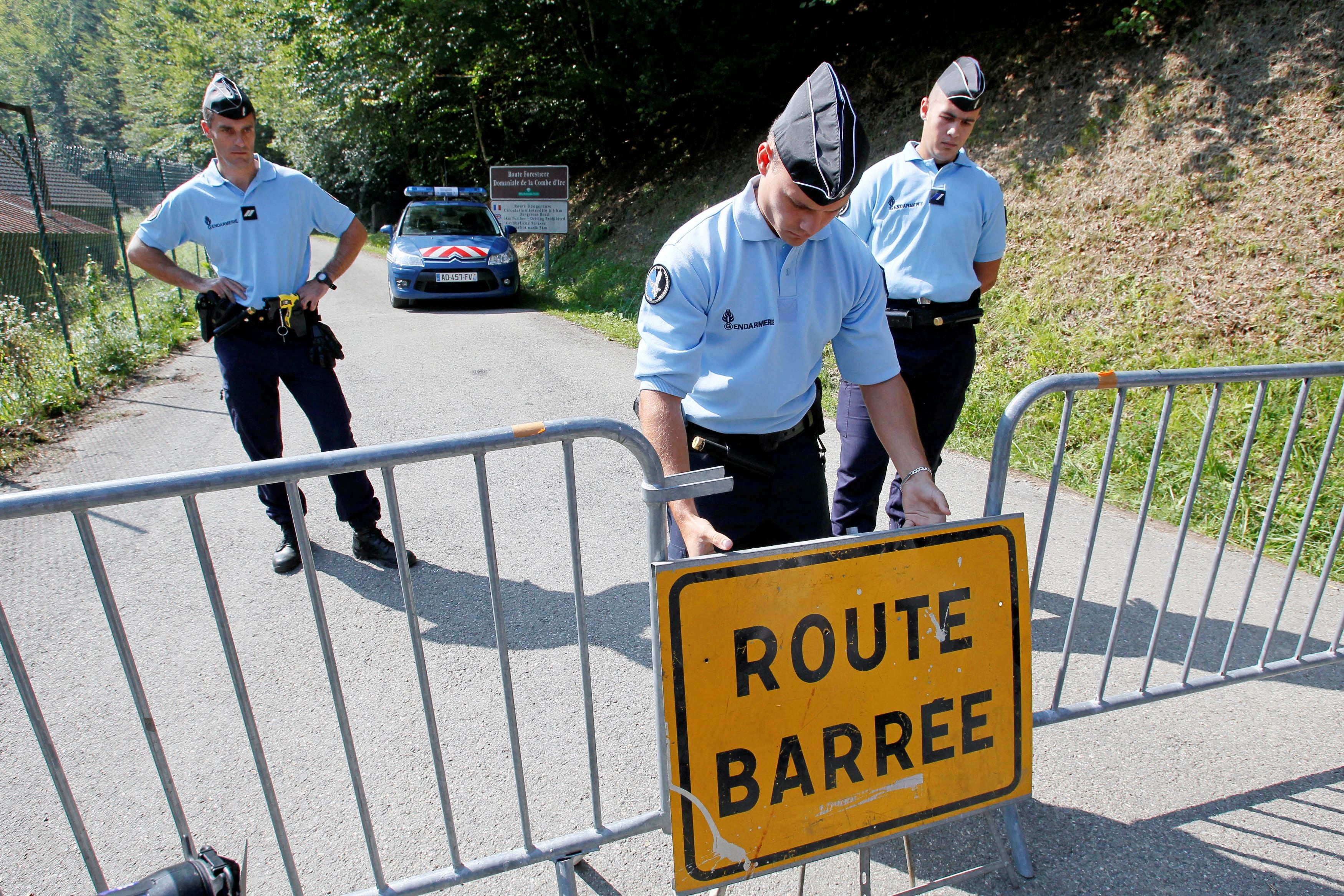 French gendarmes block access to a road to La Combe d'Ire in Chevaline near Annecy, southeastern France, September 6, 2012