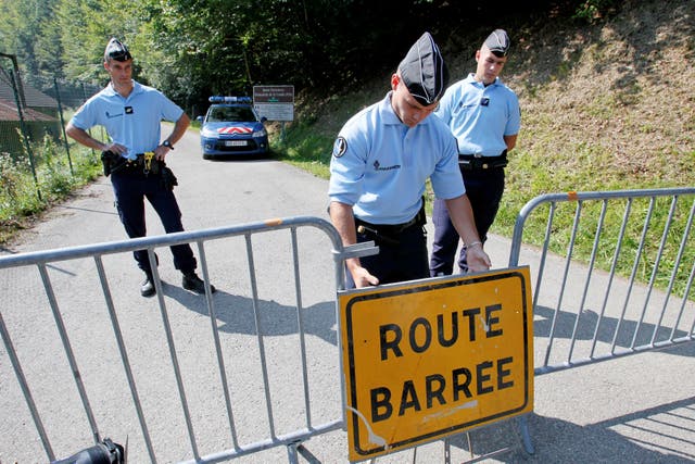 <p>French gendarmes block access to a road to La Combe d'Ire in Chevaline near Annecy, southeastern France, September 6, 2012</p>
