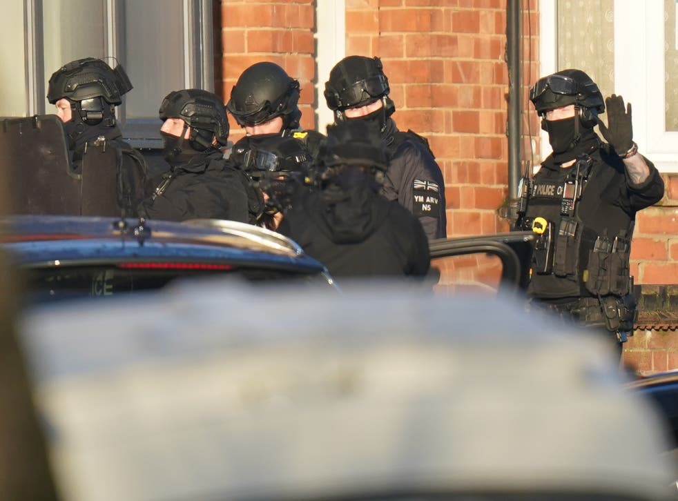 Armed police officers outside a property in Earlsdon Avenue North, Coventry (PA)