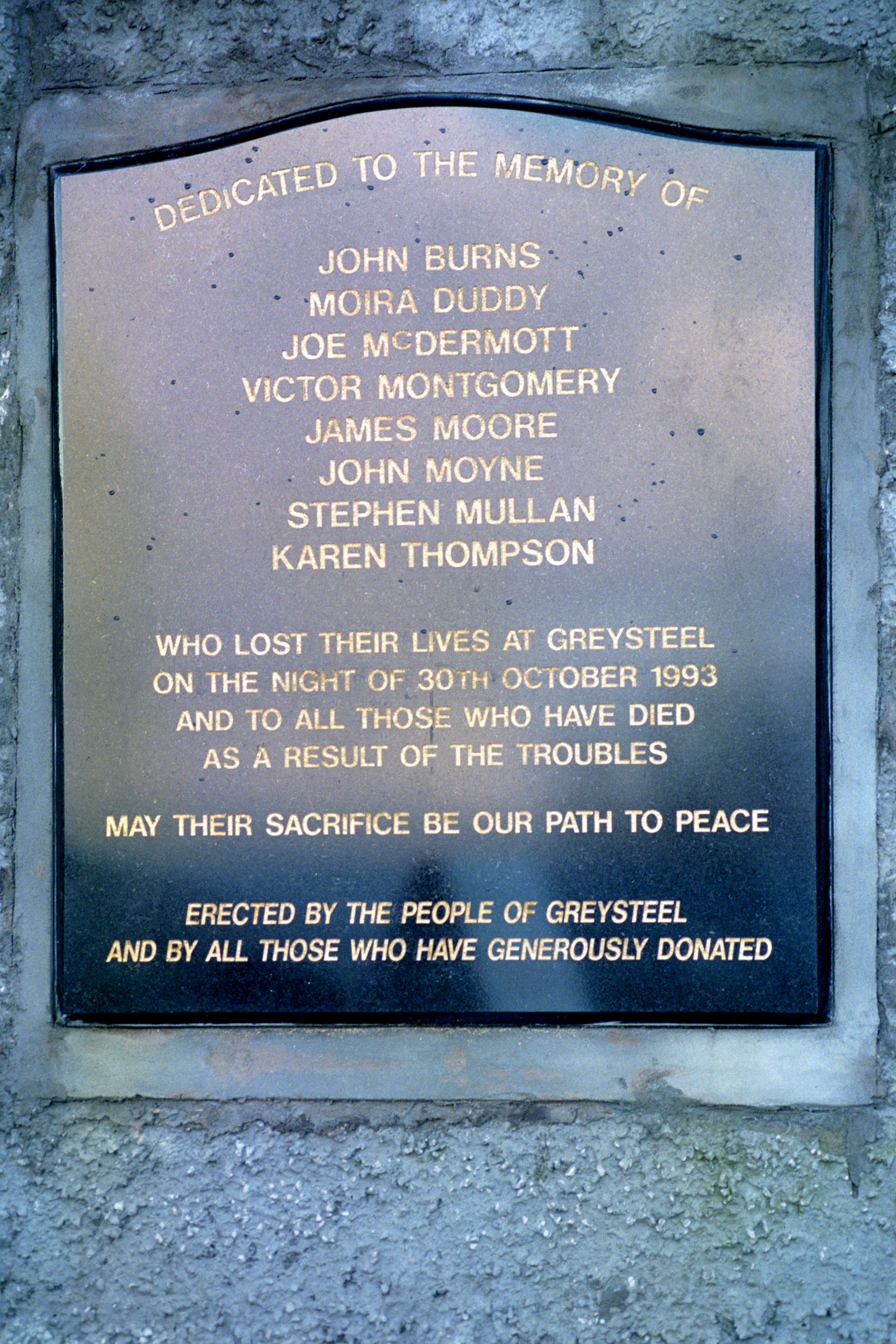 A memorial stone erected near the scene of the Greysteel massacre (PA)