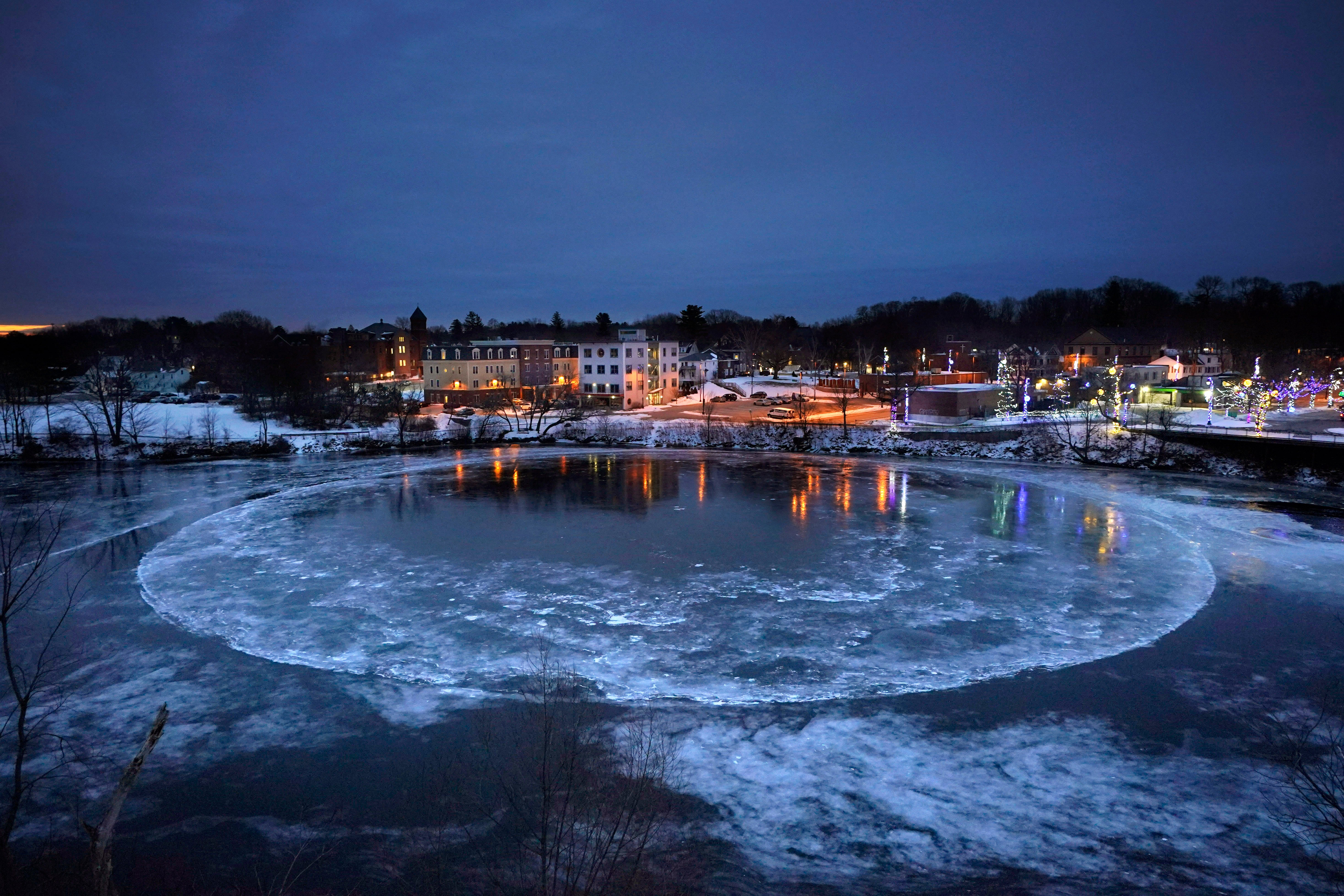 A large ice disk slowly rotates in the Presumpscot River in Westbrook, Maine, Thursday, 13 Jan 2022