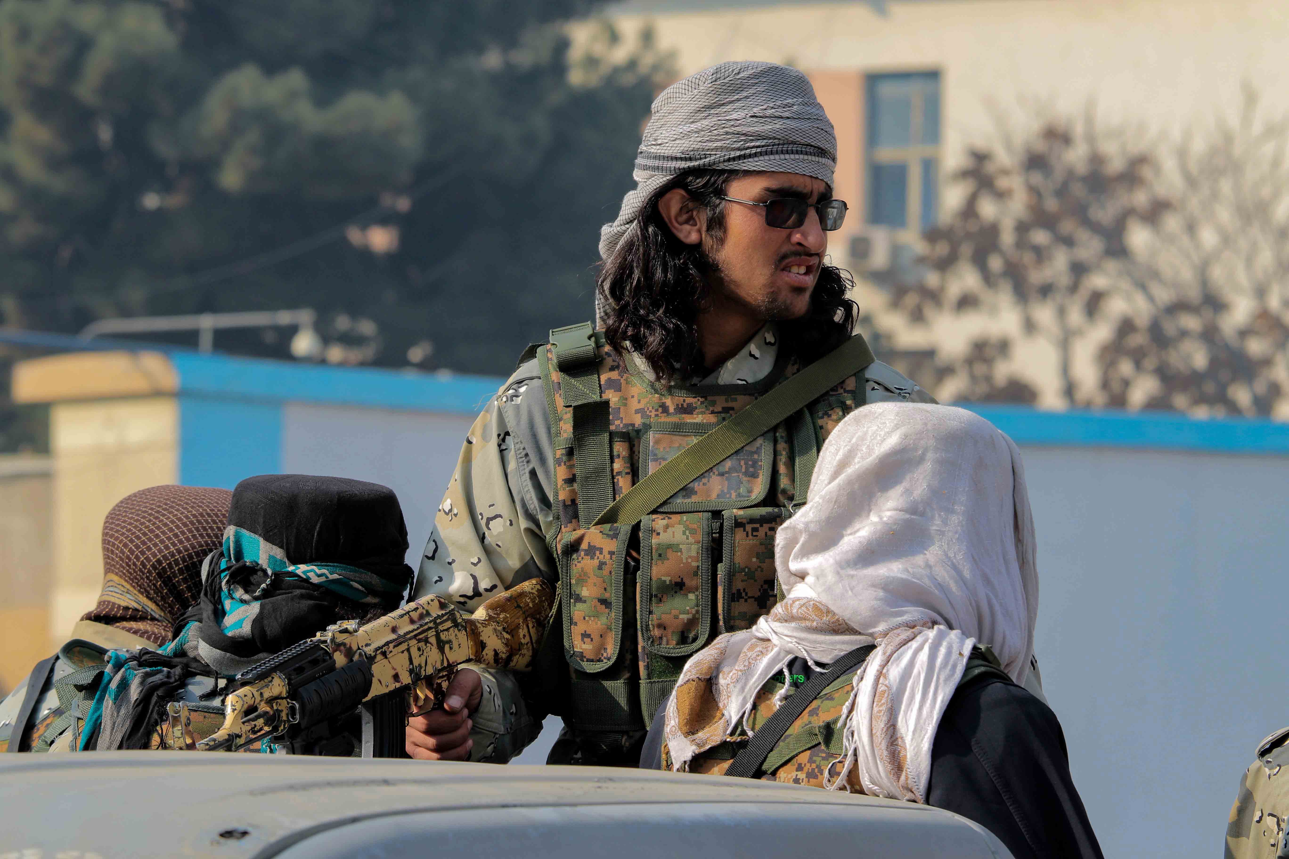 The Taliban patrol during a protest by Afghans outside the building of the former US embassy