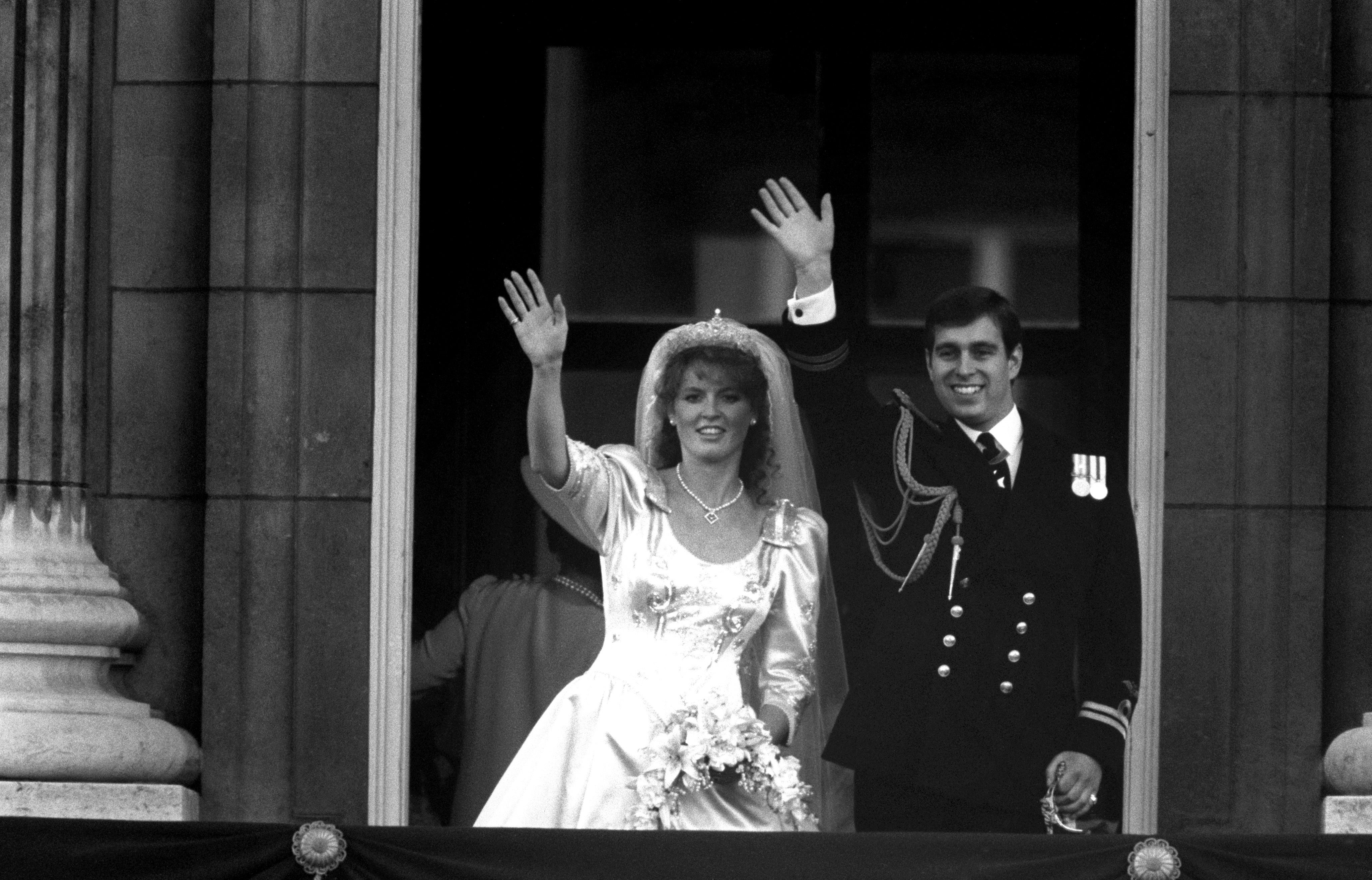 The newly created Duke of York and Duchess of York wave from the balcony of Buckingham Palace after their marriage at Westminster Abbey (PA)