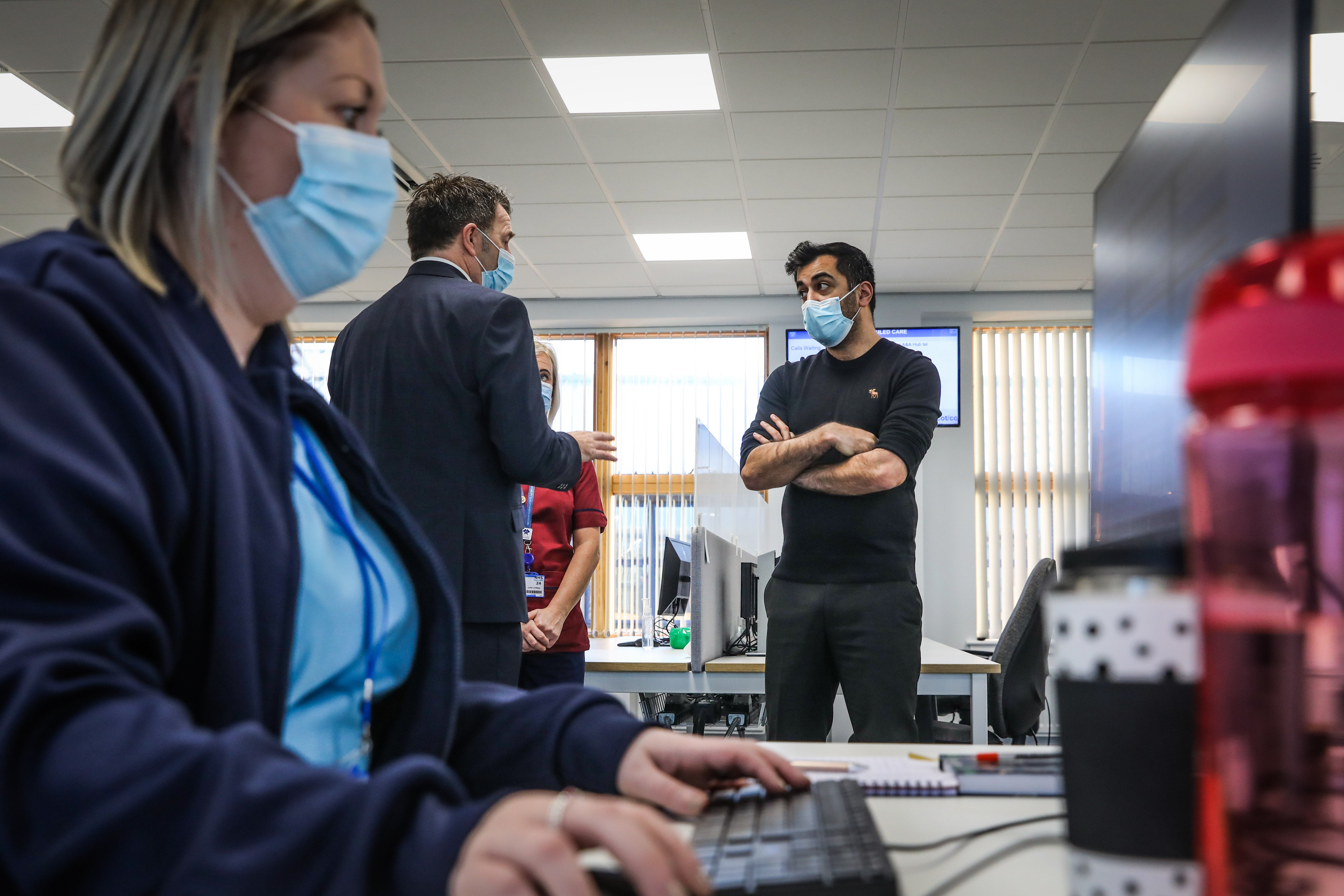 Humza Yousaf speaks to Jim Miller, NHS24 chief executive (Mhairi Edwards/The Courier/PA)