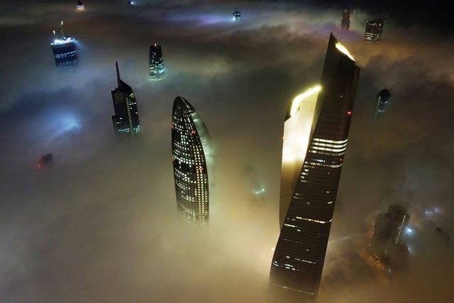 <p>Kuwait City's al-Hamra tower (R), the headquarters of The National Bank of Kuwait (C) and the al-Rayah tower (L), caught in heavy fog</p>