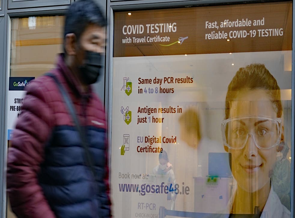 People pass a Covid-19 testing centre in Dublin city centre as the Government is to consider plans to relax the rules around close contacts, following public health advice (PA)