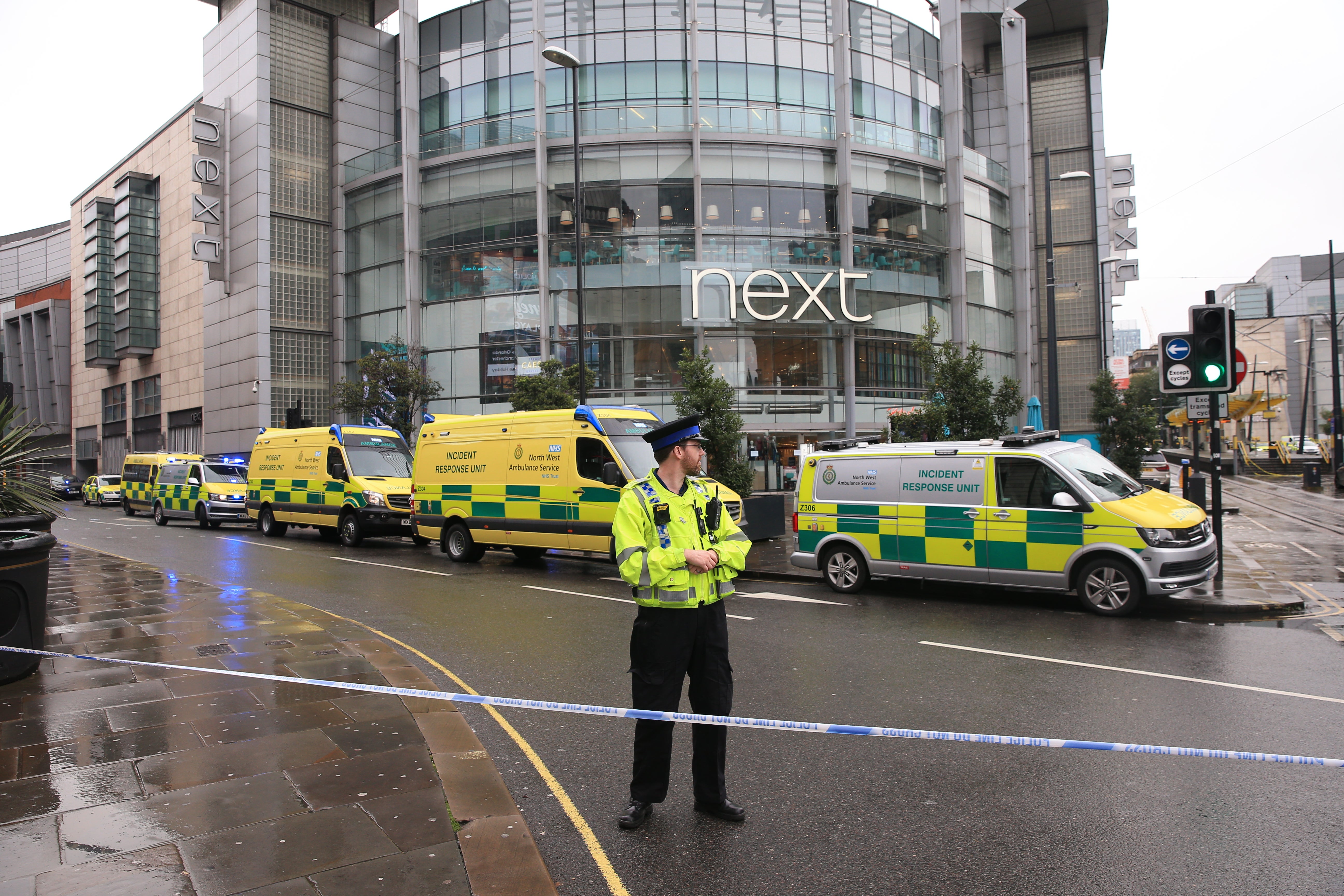 A police officer and ambulances outside the Arndale Centre in Manchester (Peter Byrne/PA)
