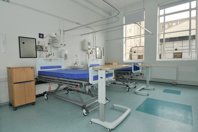 NHS England has called on healthcare officials to consider taking legal action against patients who refuse to give up their hospital beds if further care options are available (PA)