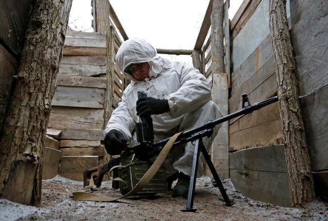 <p>A militant of the self-proclaimed Donetsk People's Republic (DNR) checks a machine gun at fighting positions in Donetsk region</p>