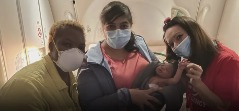 A Toronto-based doctor, Aisha Khatib (middle) helped a woman deliver a baby during an overnight flight from Qatar to Uganda. Screengrab
