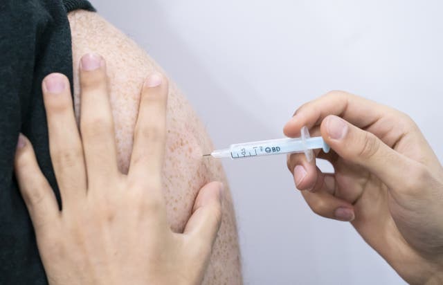 A booster coronavirus vaccine is administered at a Covid vaccination centre at Elland Road in Leeds, as the booster vaccination programme continues across the UK (Danny Lawson/PA)