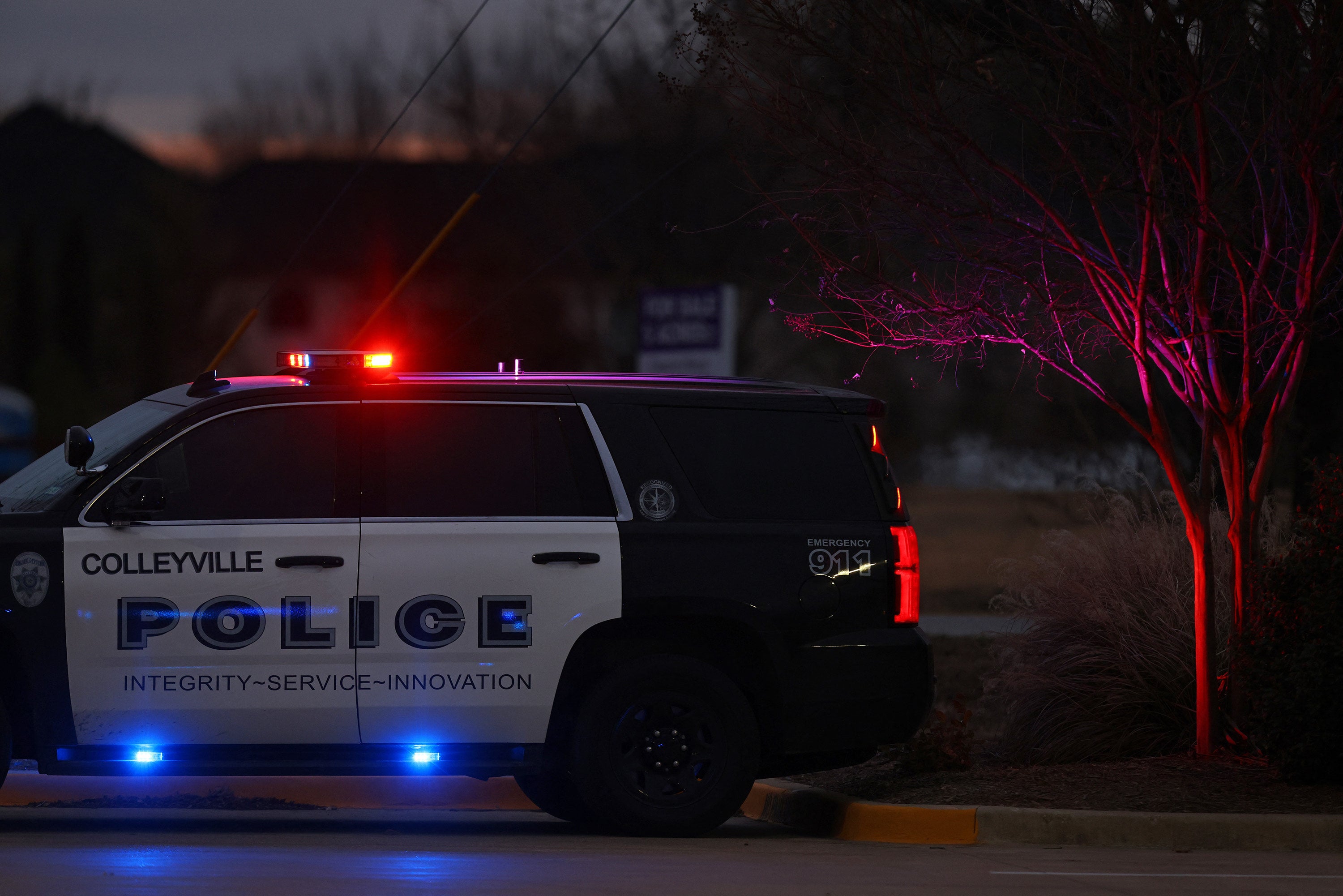 A Police car is seen driving close to the Congregation Beth Israel Synagogue in Colleyville, Texas, some 25 miles west of Dallas, on 15 January 2022
