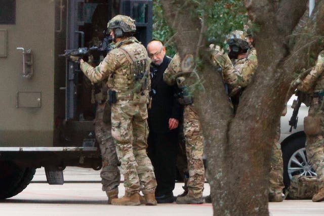 <p>Authorities escort a hostage out of the Congregation Beth Israel synagogue</p>