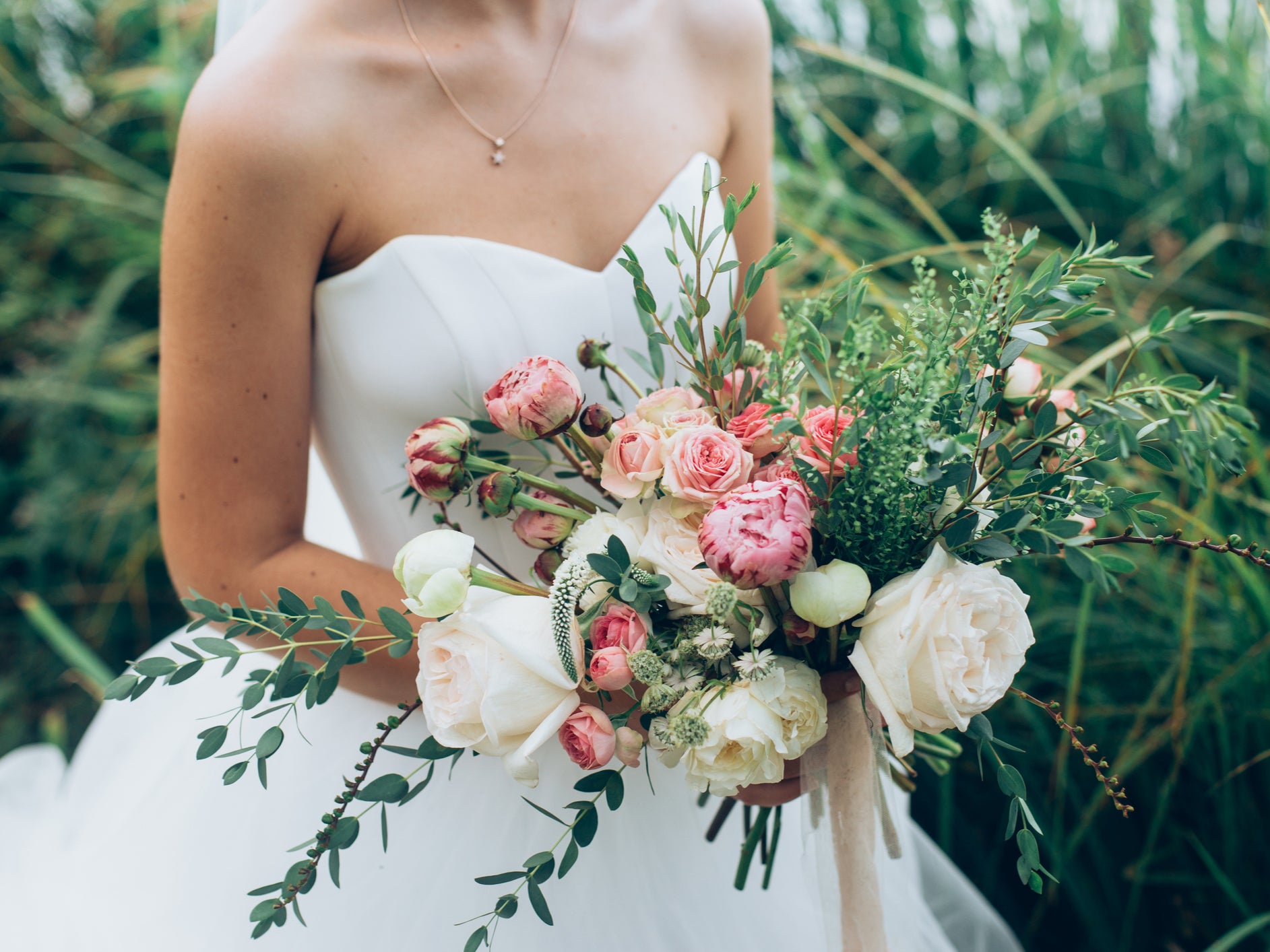 A bride holds a bouquet of flowers