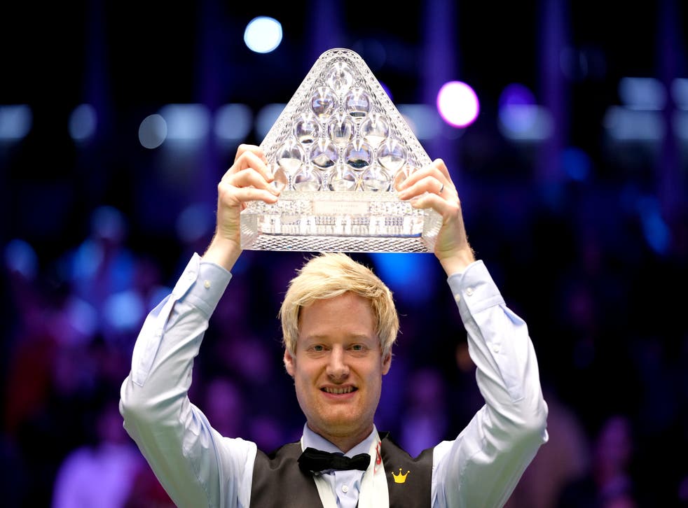 Neil Robertson celebrates with the Paul Hunter trophy after his 10-4 Masters victory over Barry Hawkins (John Walton/PA)