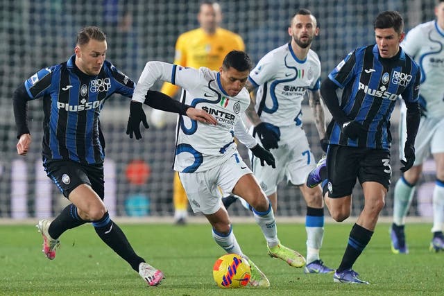 Alexis Sanchez, centre, attempts to break through for Serie A leaders Inter Milan against Atalanta (Spada/LaPresse via AP)