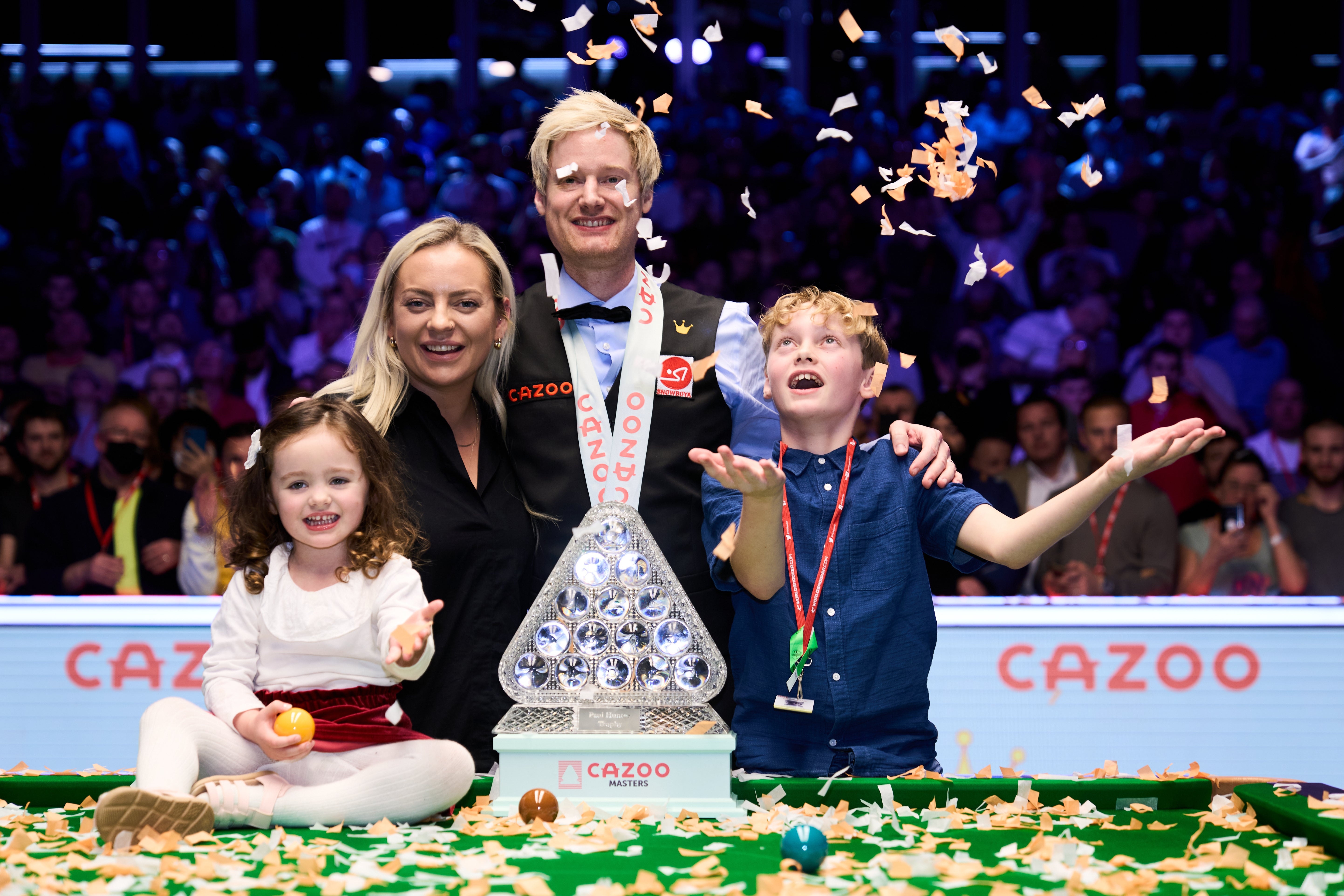 Neil Robertson celebrates his Masters triumph at Alexandra Palace alongside his wife Mille, daughter Penelope and son Alexander (John Walton/PA)