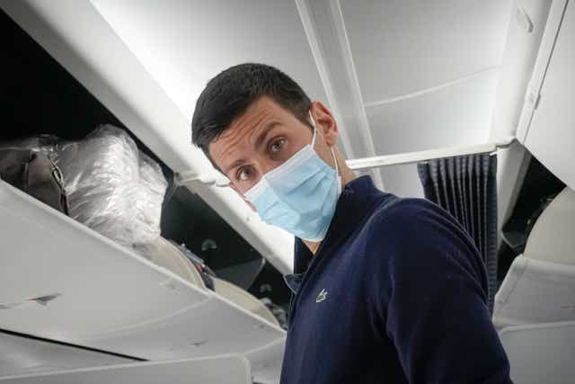Novak Djokovic pictured on a plane bound for Serbia on Monday (Darko Bandic/AP)