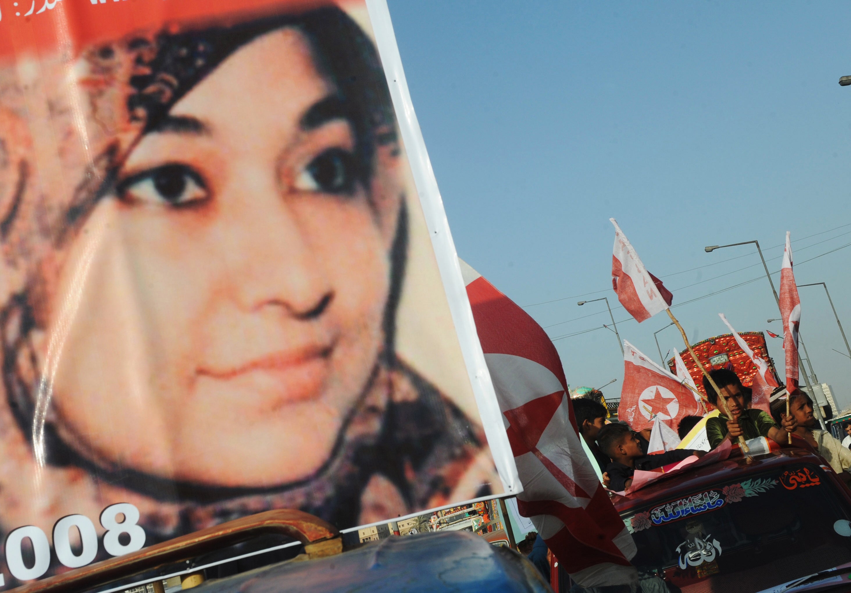 File Supporters of US-detained Pakistani woman Aafia Siddiqui carry flags and placards with her portrait during an anti-US demonstration in Karachi on 28 March, 2010