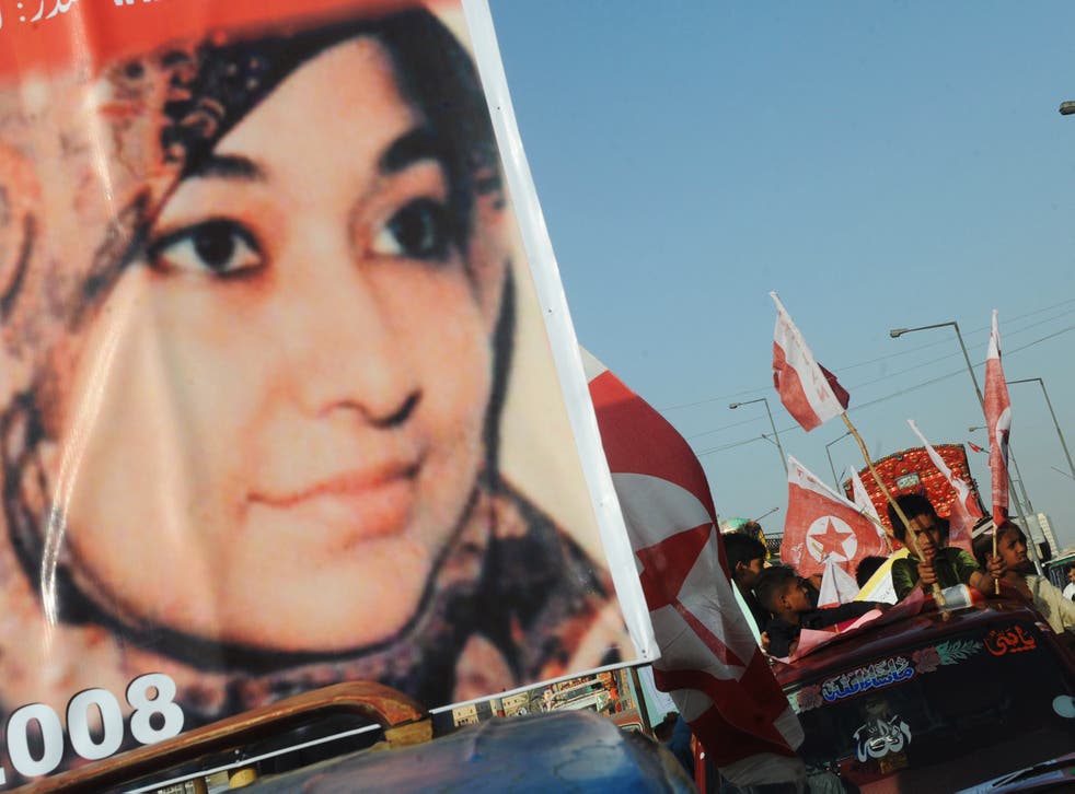 <p>File Supporters of US-detained Pakistani woman Aafia Siddiqui carry flags and placards with her portrait during an anti-US demonstration in Karachi on 28 March, 2010</p>