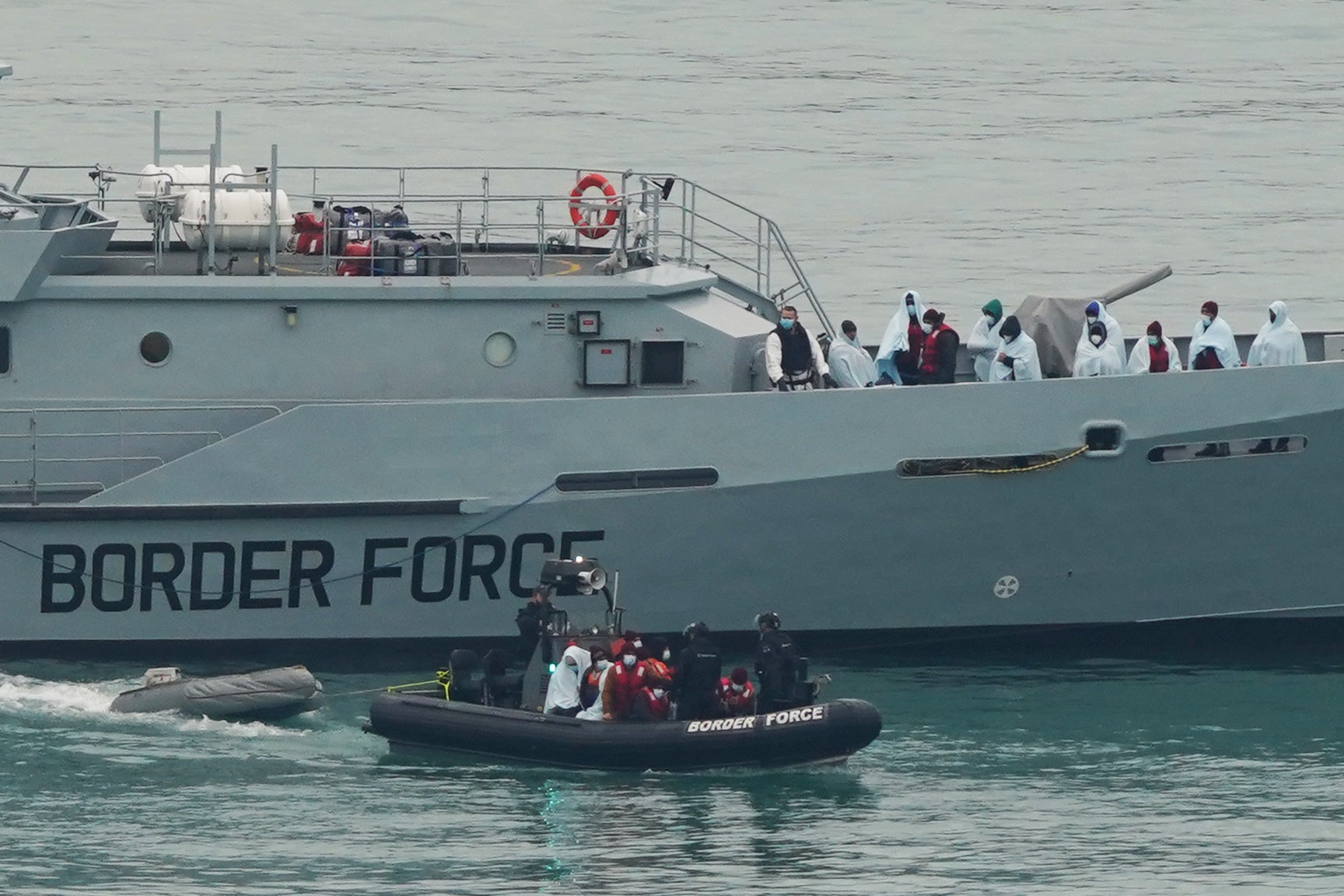 A group of people thought to be migrants are brought in to Dover, Kent, by Border Force officers (Gareth Fuller/PA)