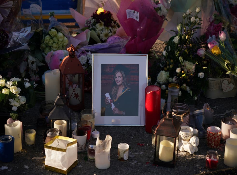 Floral tributes and candles surround a photographer left at the Grand Canal in Tullamore, Co Offaly, where primary school teacher Ashling Murphy was found dead after going for a run on Wednesday afternoon (Niall Carson/PA)