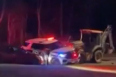 Dramatic video shows police fatally shoot man who was driving a backhoe into homes and cars
