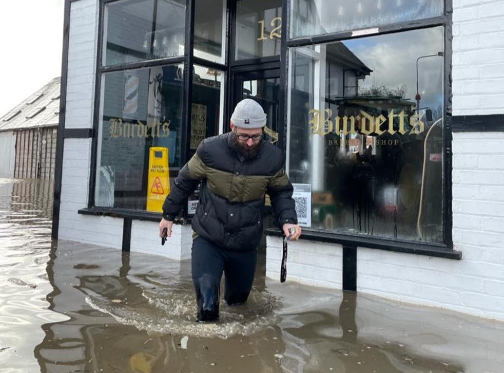 <p>Brent Nile outside his barber shop during the flooding</p>