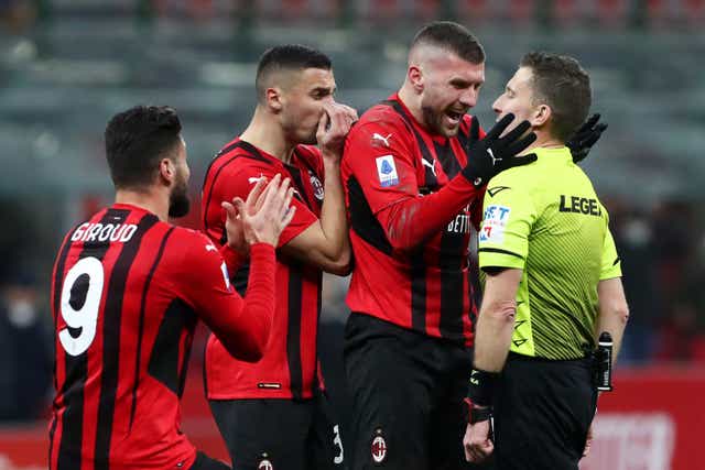 <p>Referee Marco Serra is surrounded by furious Milan players</p>