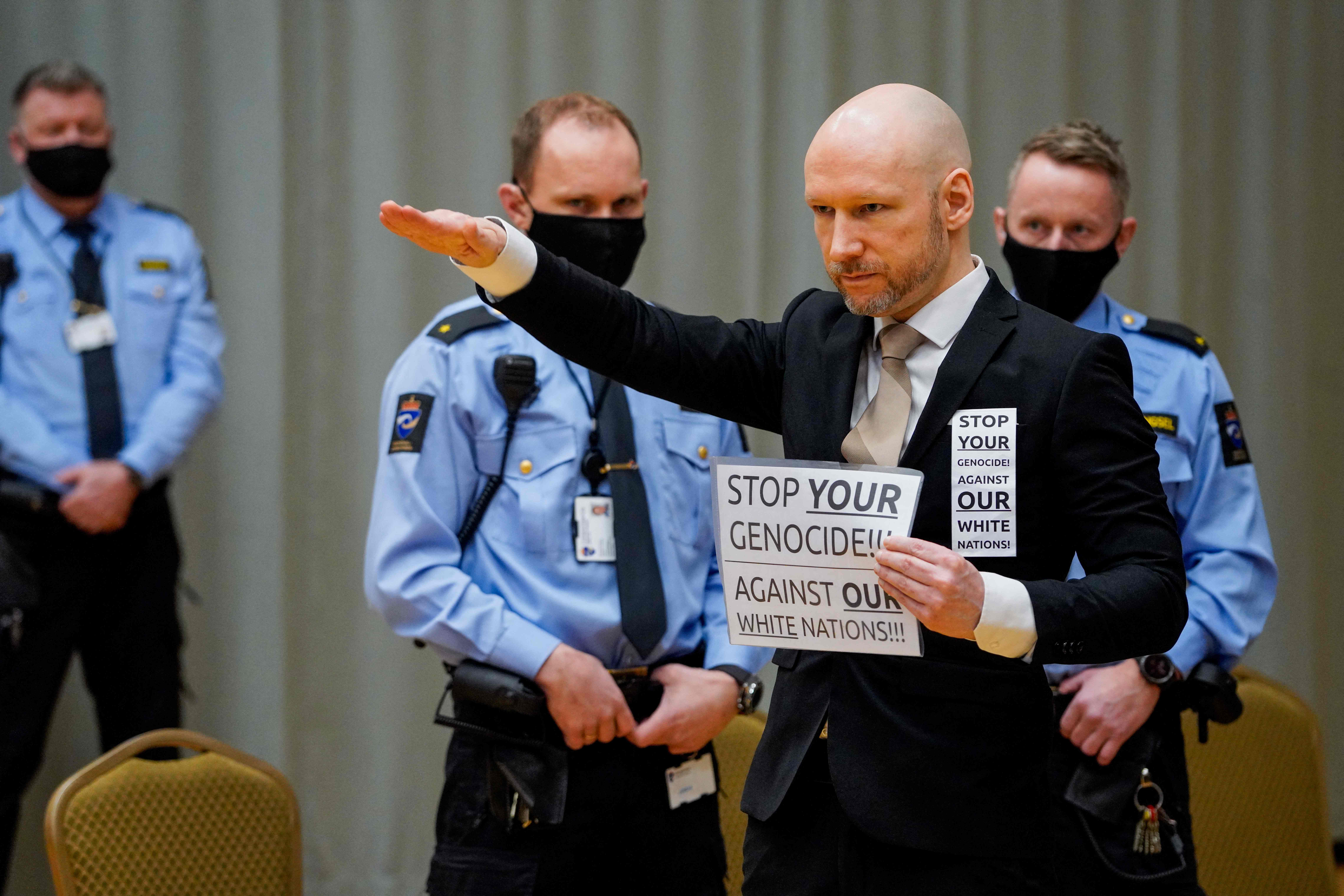 <p>Killer Anders Behring Breivik raises his arm to make a Nazi salute as he arrives on the first day of his parole hearing</p>