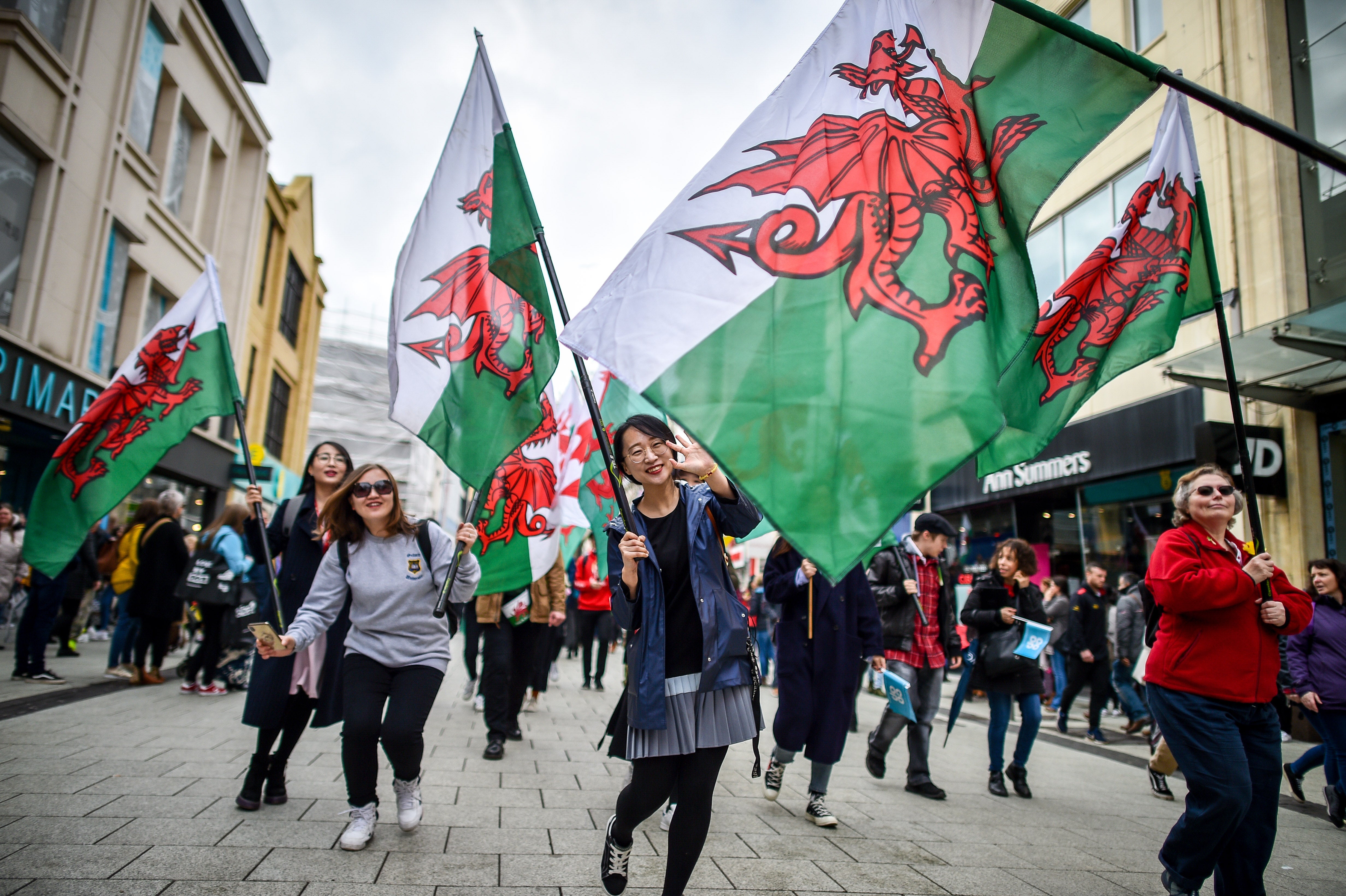 People take part in a St David’s Day parade in Cardiff (Ben Birchall/PA)