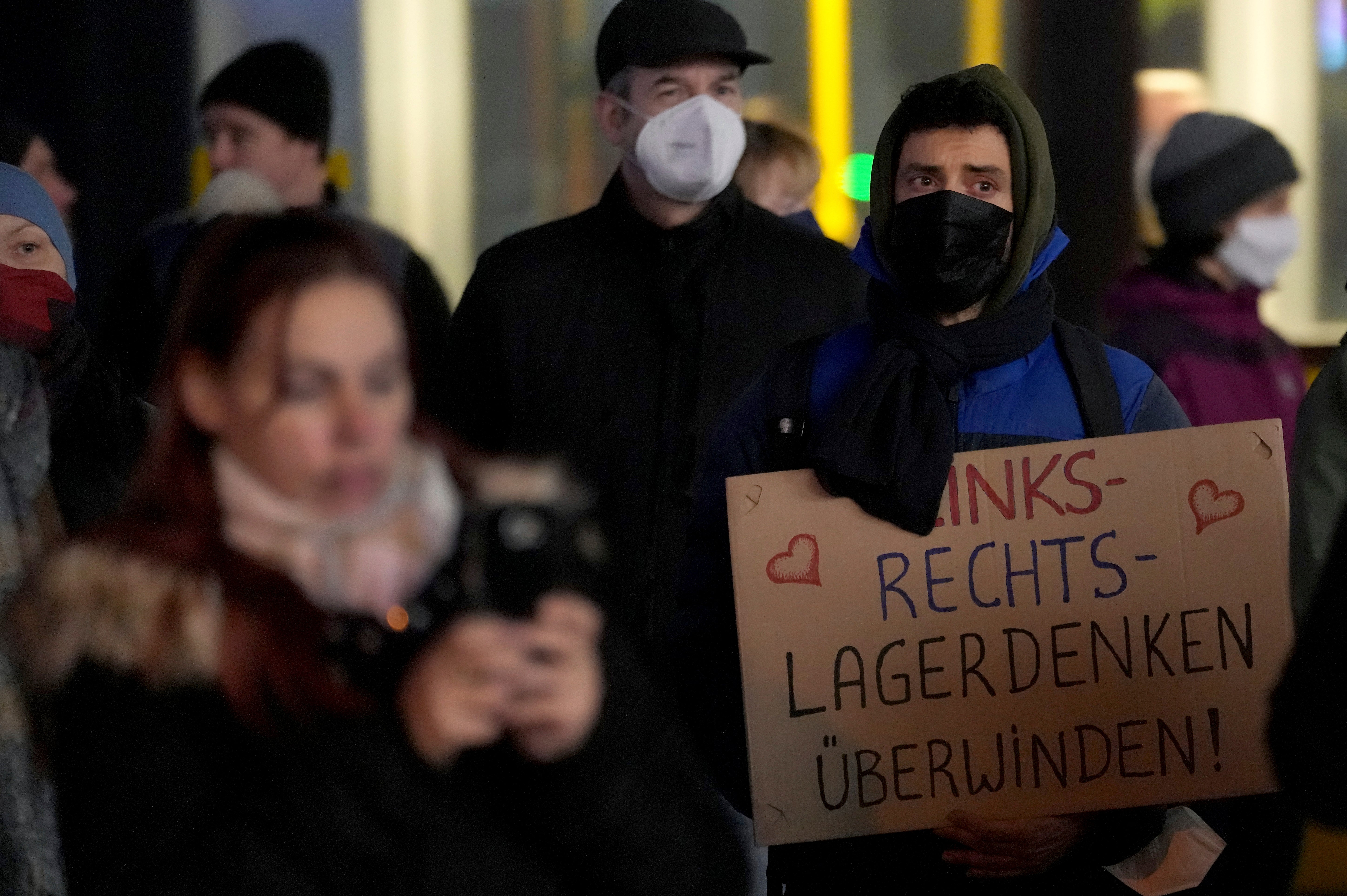 People gather at the Alexanderplatz in Berlin to protest against Covid measures and a possible compulsory vaccination. Slogan reads: ‘Defeat Left-Right-Stereotype Thinking’