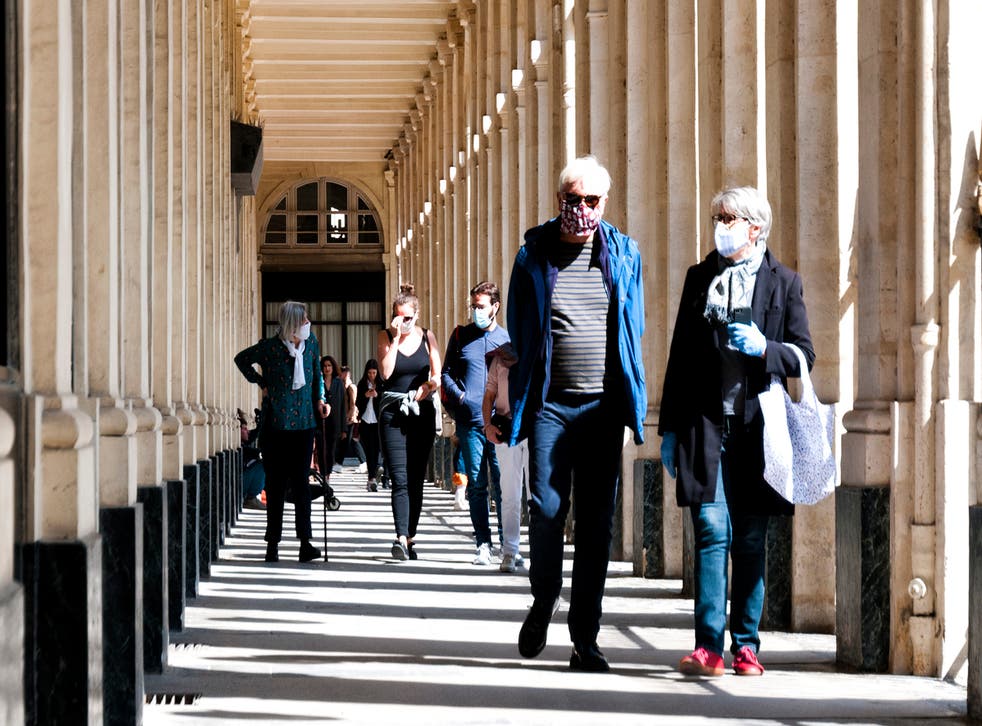 <p>Masked tourists near Palais Royal, Paris</p>