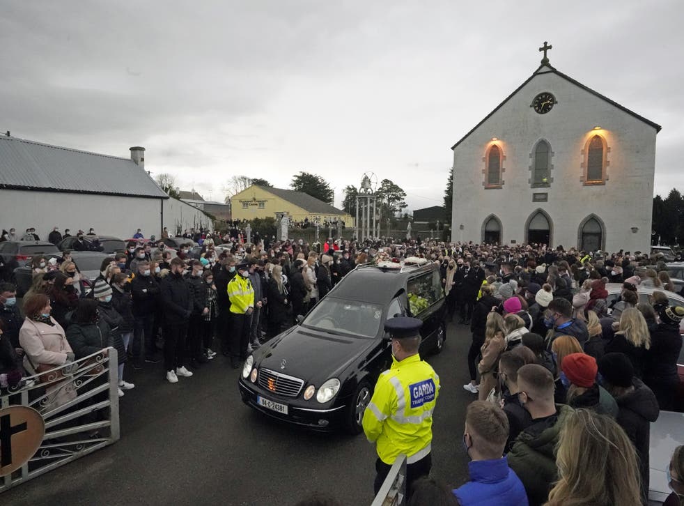 Ashling Murphy’s family and mourners walk behind the hearse as it leaves St Brigid’s Church, Mountbolus, Co Offaly, at the end of the funeral of the school teacher who was murdered in Tullamore, Co Offaly last Wednesday (PA)