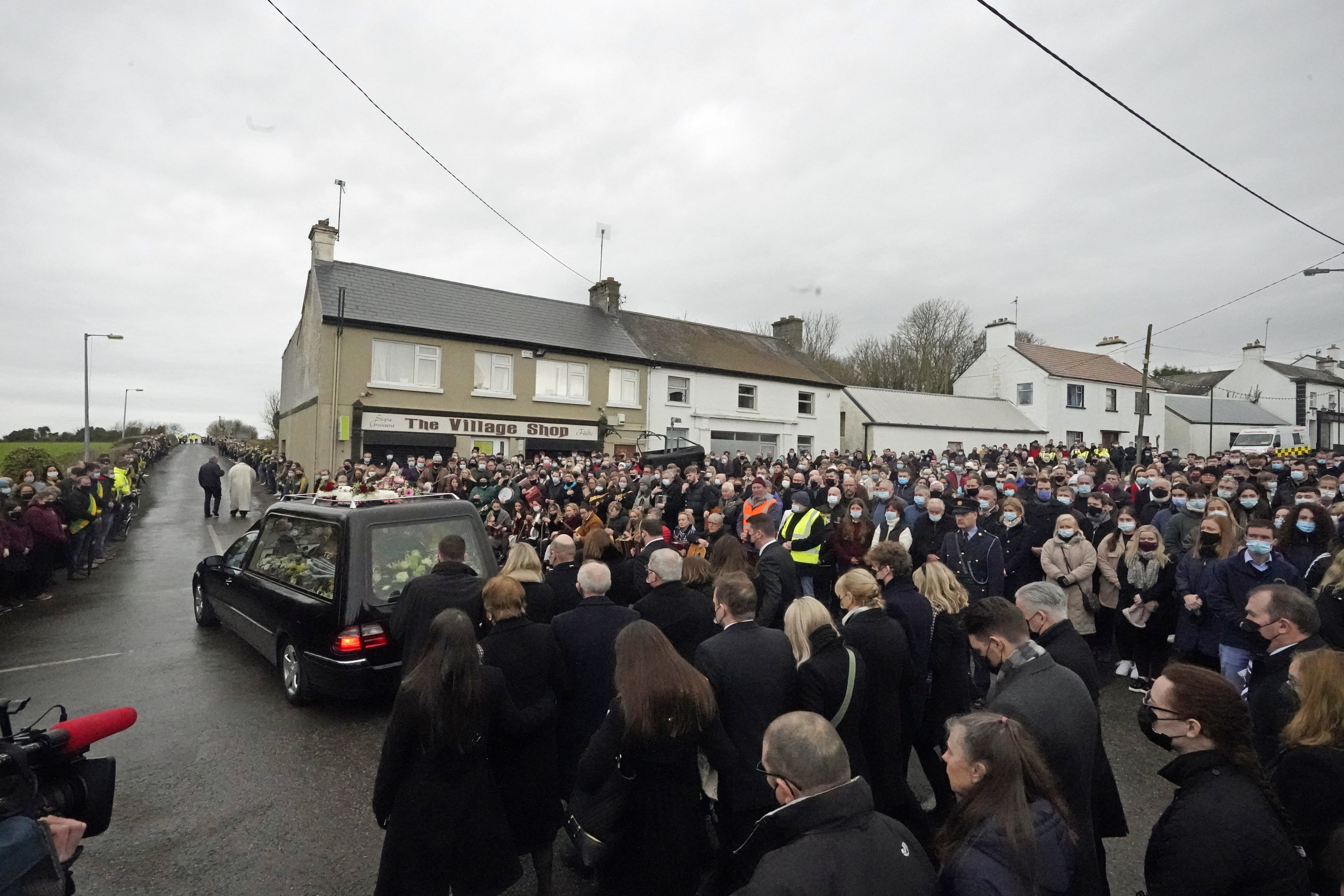 Ashling Murphy’s family and mourners walk behind the hearse as it leaves St Brigid’s Church, Mountbolus, Co Offaly (Niall Carson/PA)