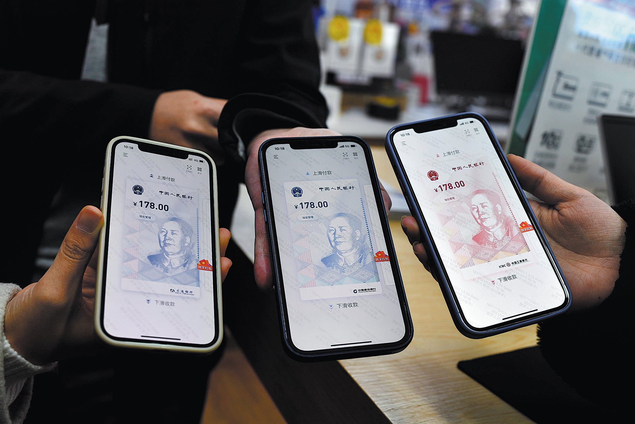 People show their e-CNY digital wallets in Chengdu, Sichuan Province, in March 2021