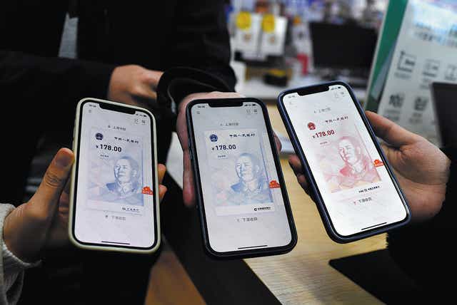<p>People show their e-CNY digital wallets in Chengdu, Sichuan Province, in March 2021 </p>
